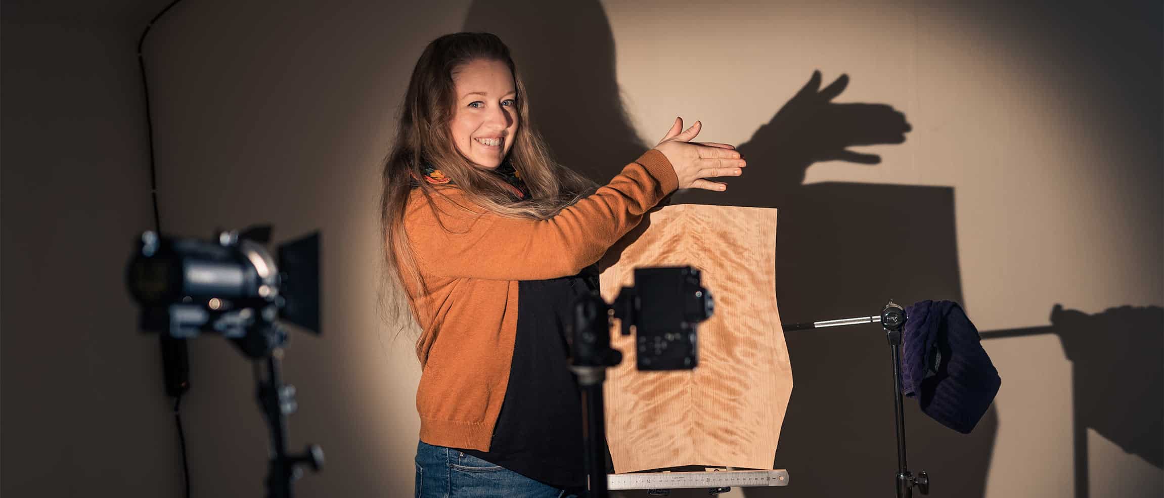 Ruokangas Guitars 2 Emma Elftorp behind cameras with a flame birch guitar top